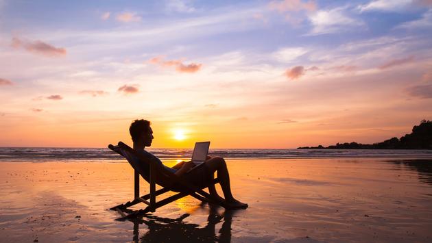 bleisure, digital nomad, remote working, laptop, beach, sunset