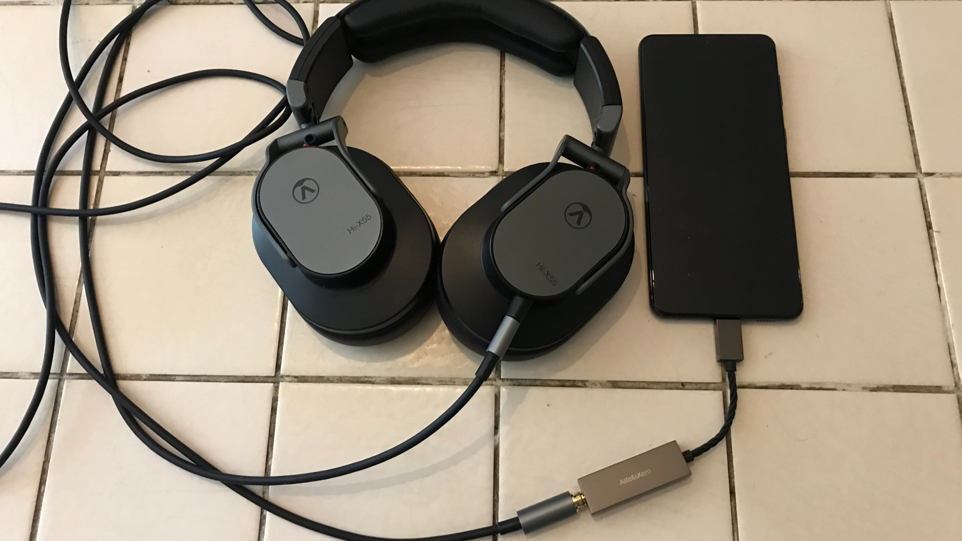 A&K's Dual DAC, Austrian Audio Hi-X55 and Samsung Galaxy S21 on a white table