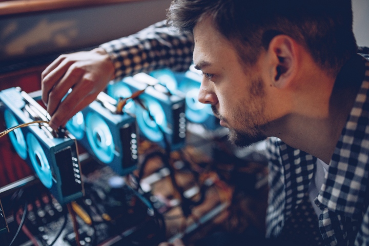 A programmer preparing a crypto currency mining rig.