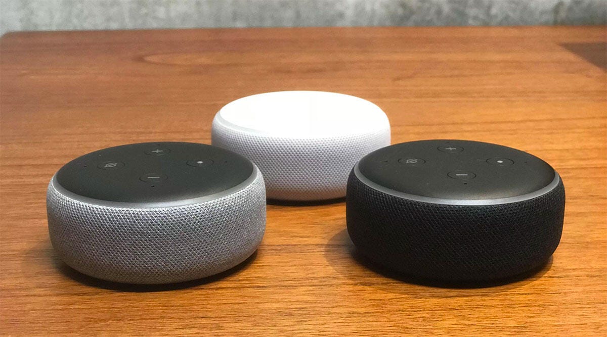 Three Amazon Echo Dot 3rd gen speakers sitting on a table