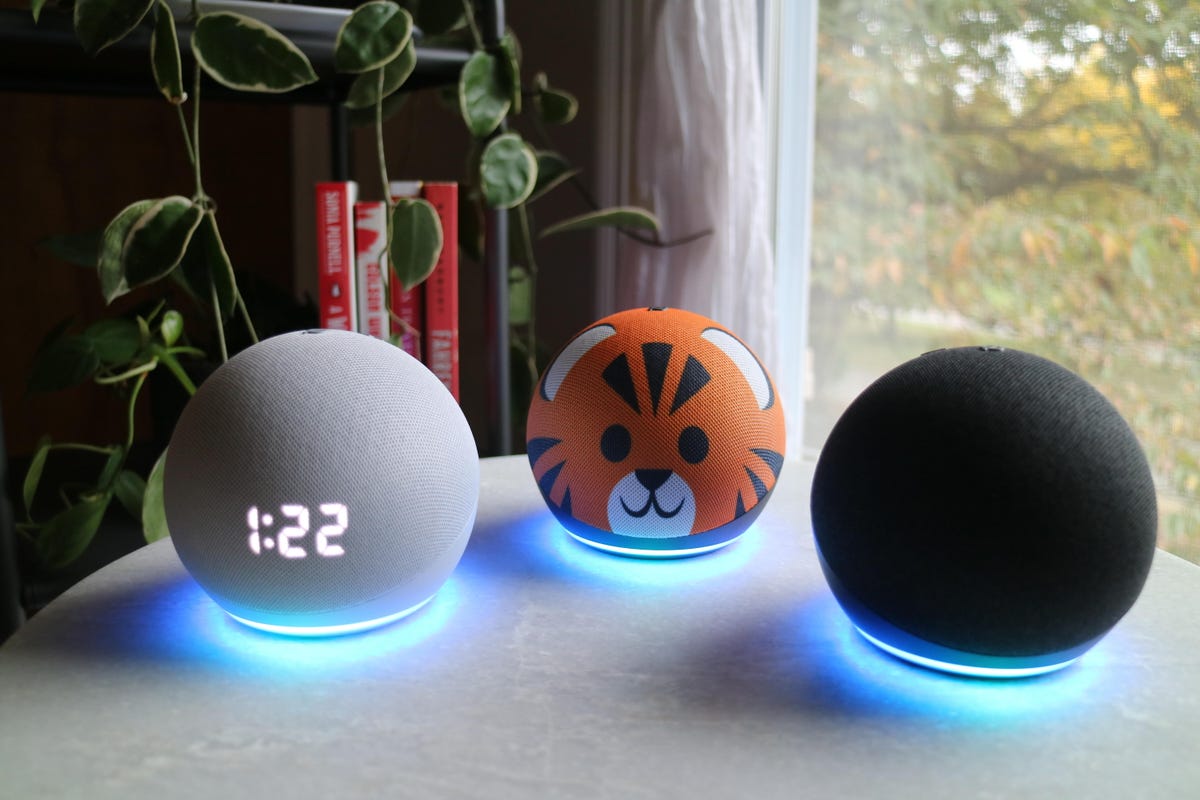 Three round Echo speakers sitting on a table