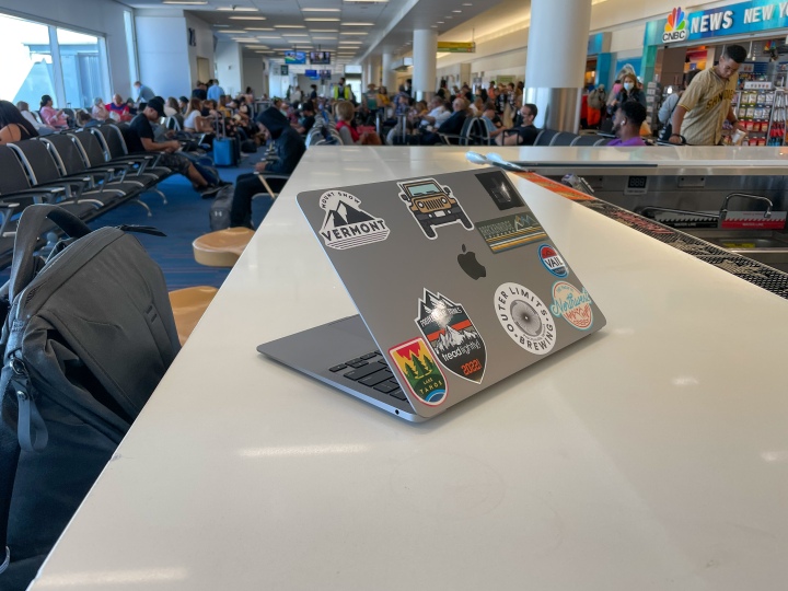 MacBook Air sitting on a table in an airport.